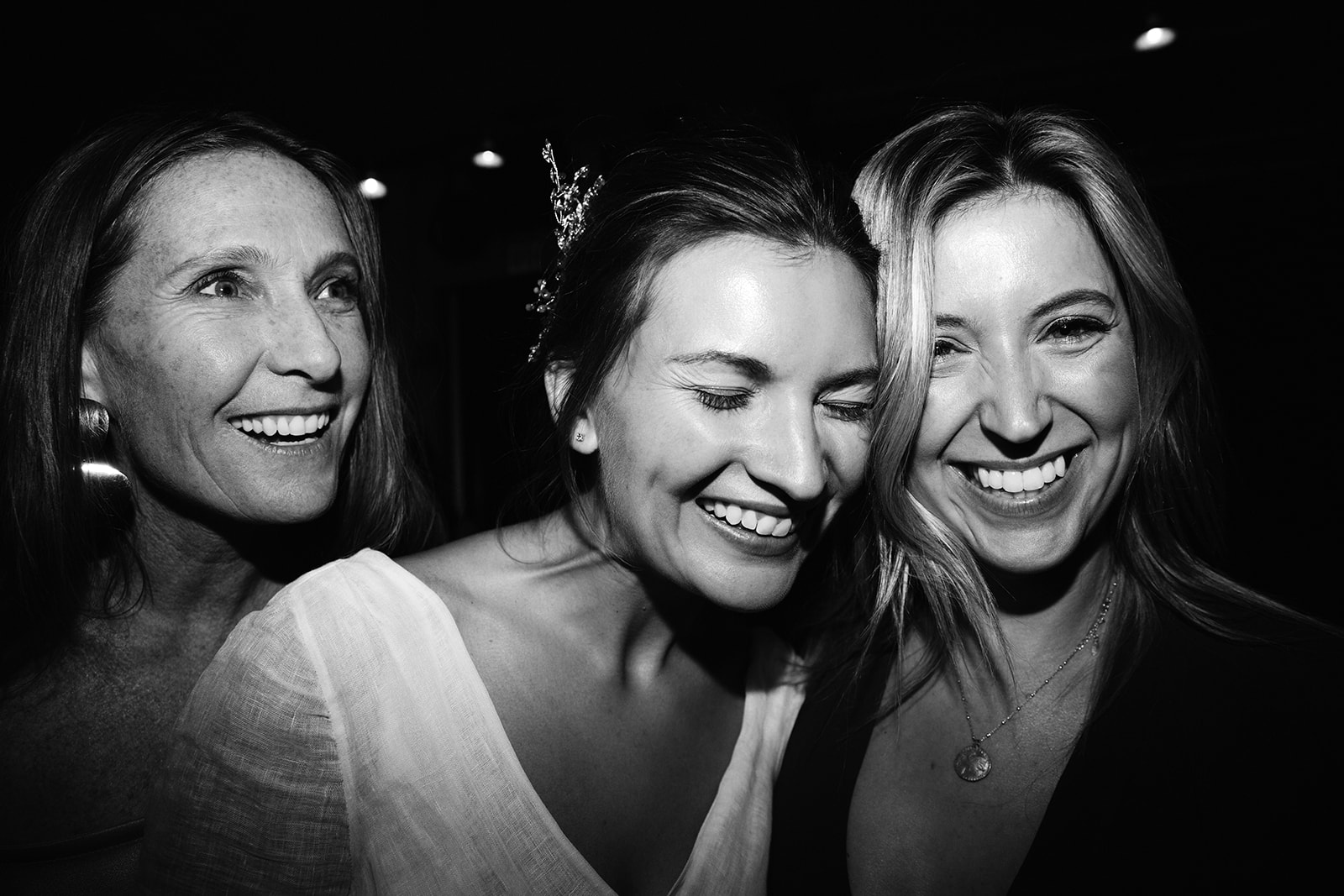 Black and white candid shot of K with her two friends laughing. The bride had a sweet way of closing her eyes when she was happy. I was able to get a lot of shots with her eyes closed like this. It adds a softness to the images. 