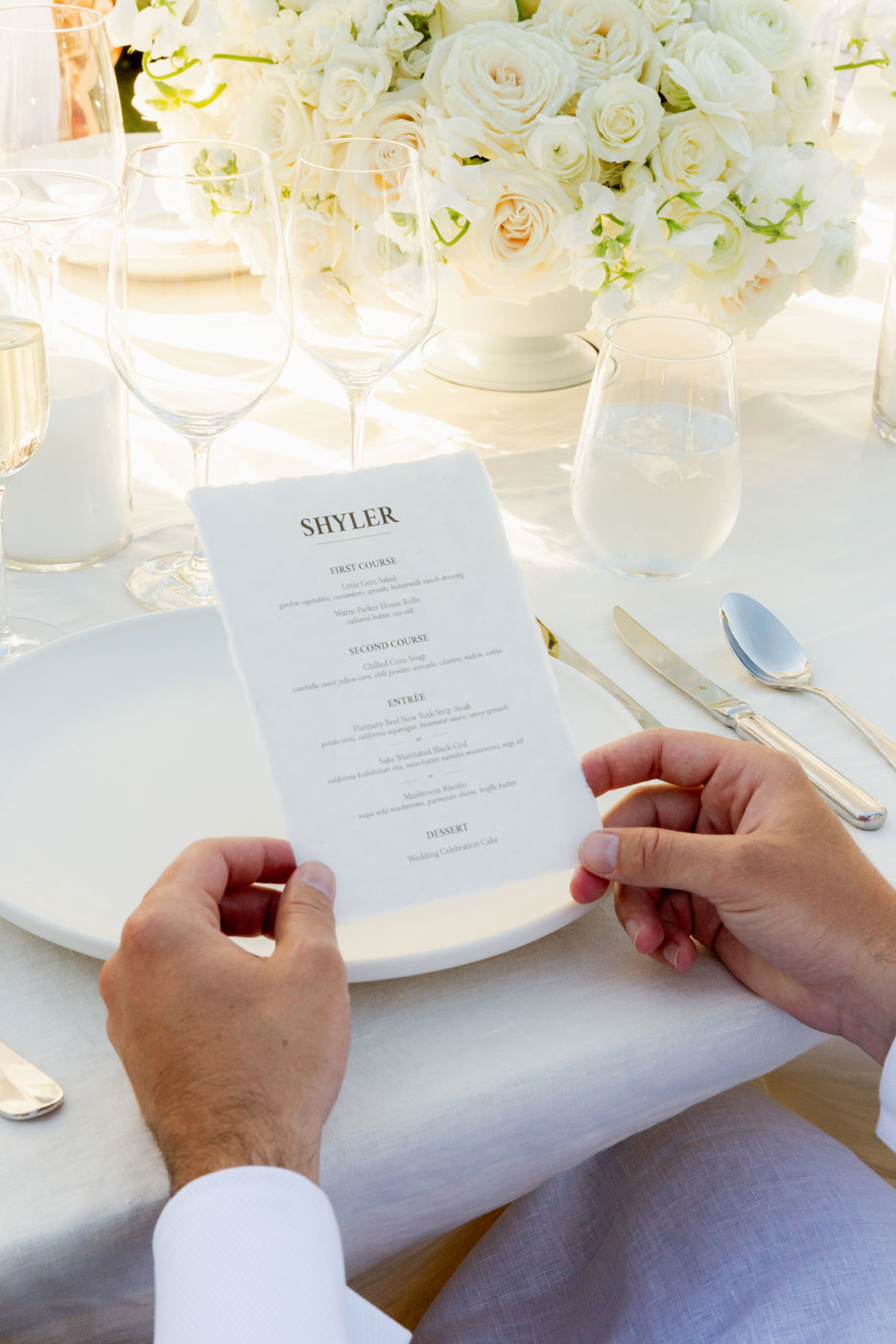 Close up shot of a man holding a menu for that nights dinner.