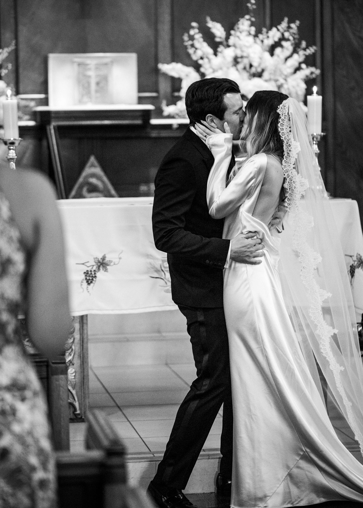 c wide shot of M and C kissing after the priest pronounces them husband and wife.