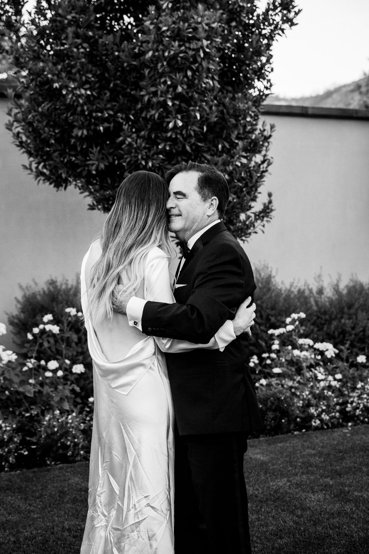 Black and white shot of bride dancing with her father.