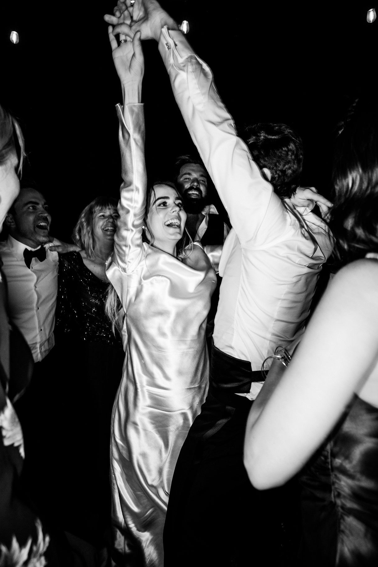 Black and white candid shot of the couple dancing the night away oblivious of the camera.
