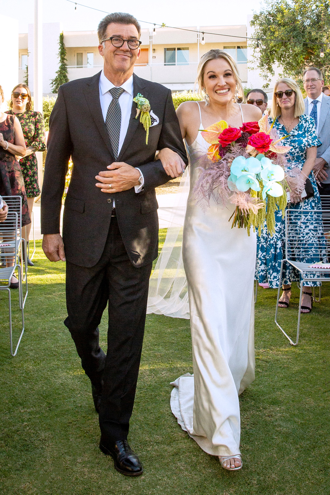 K and her dad walking down the aisle arm in arm. K surprised B with walking down to an acoustic version of one of their shared favorite songs - “Fast Car” by Tracy Chapman.