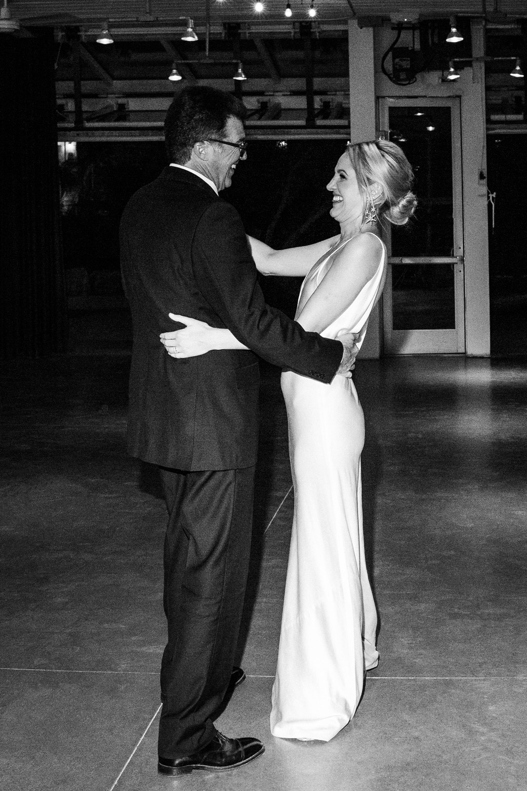 Black and white wide shot of K with her Dad having a dance.