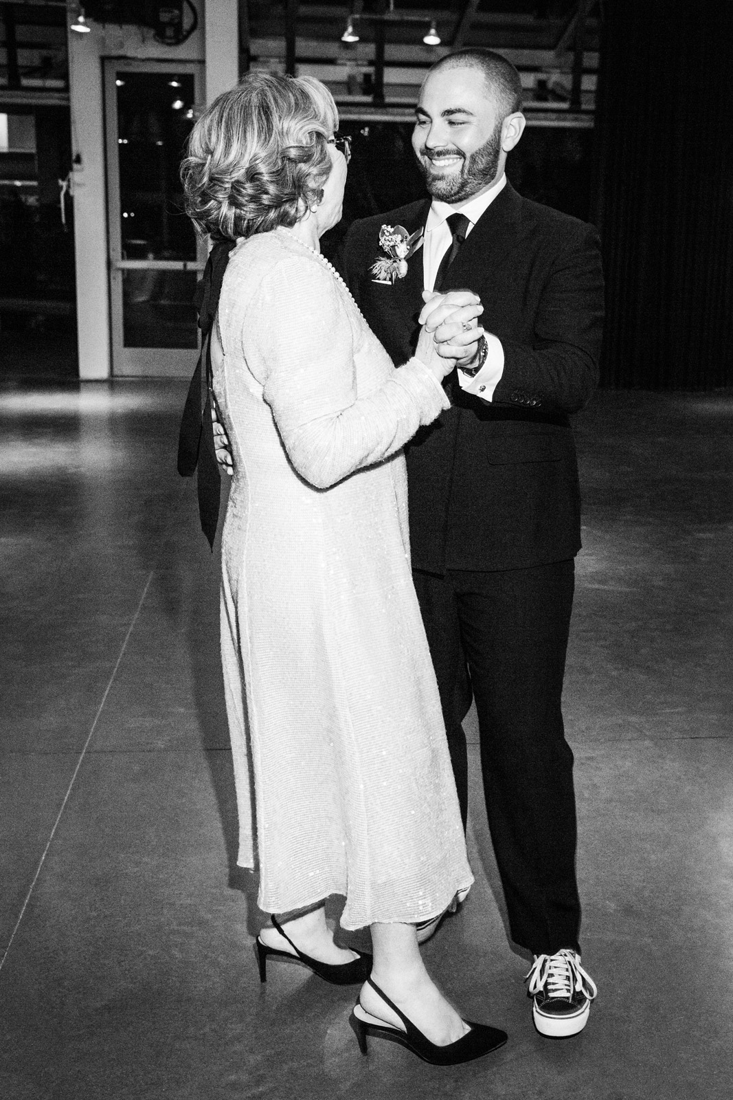 Black and white wide shot of B with his Mom having a dance.