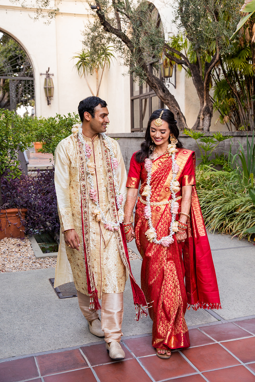 Wide full-body shot of our couple taking a stroll through the garden.