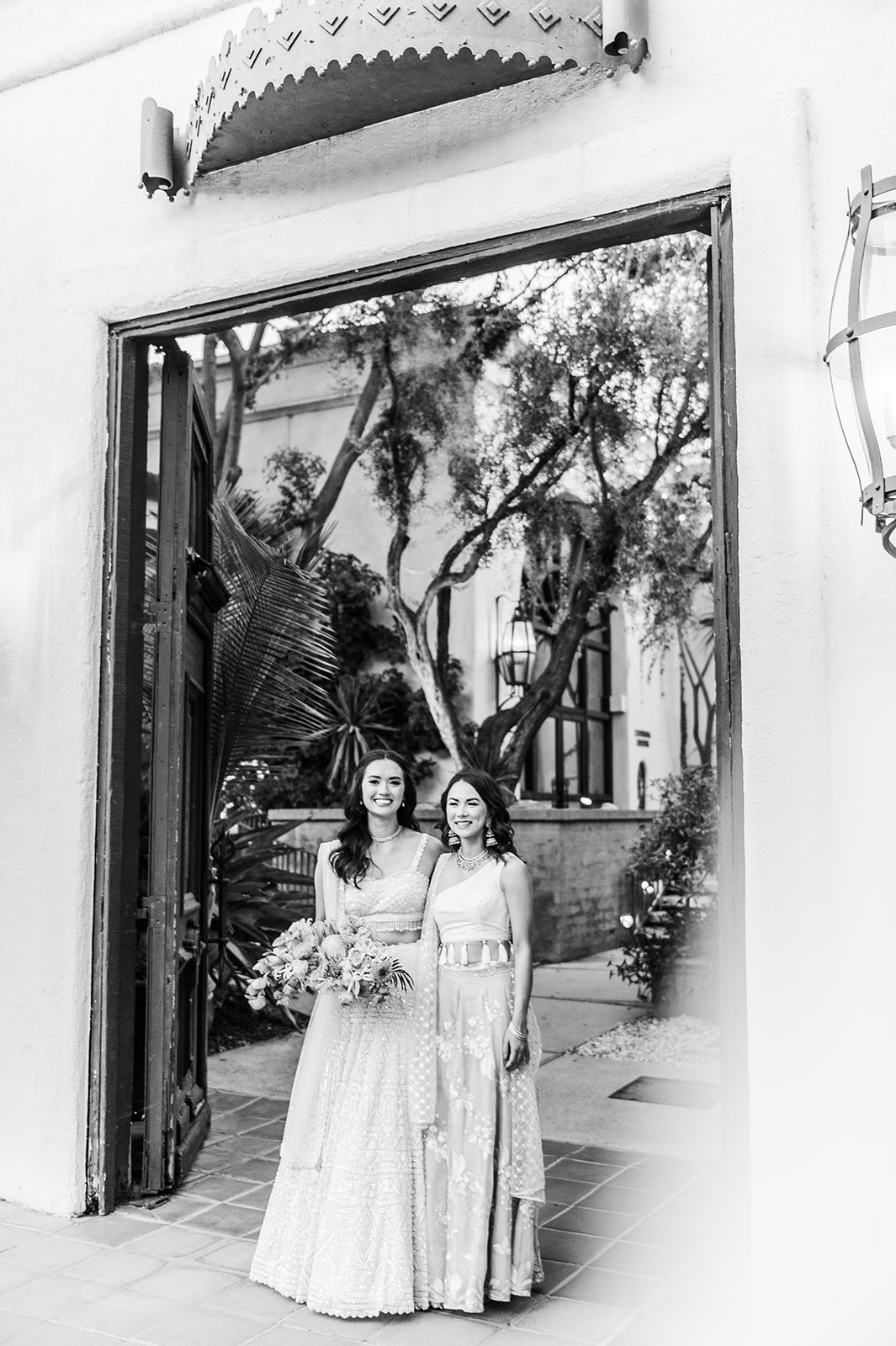 Wide black and white shot of our bride with her sister.