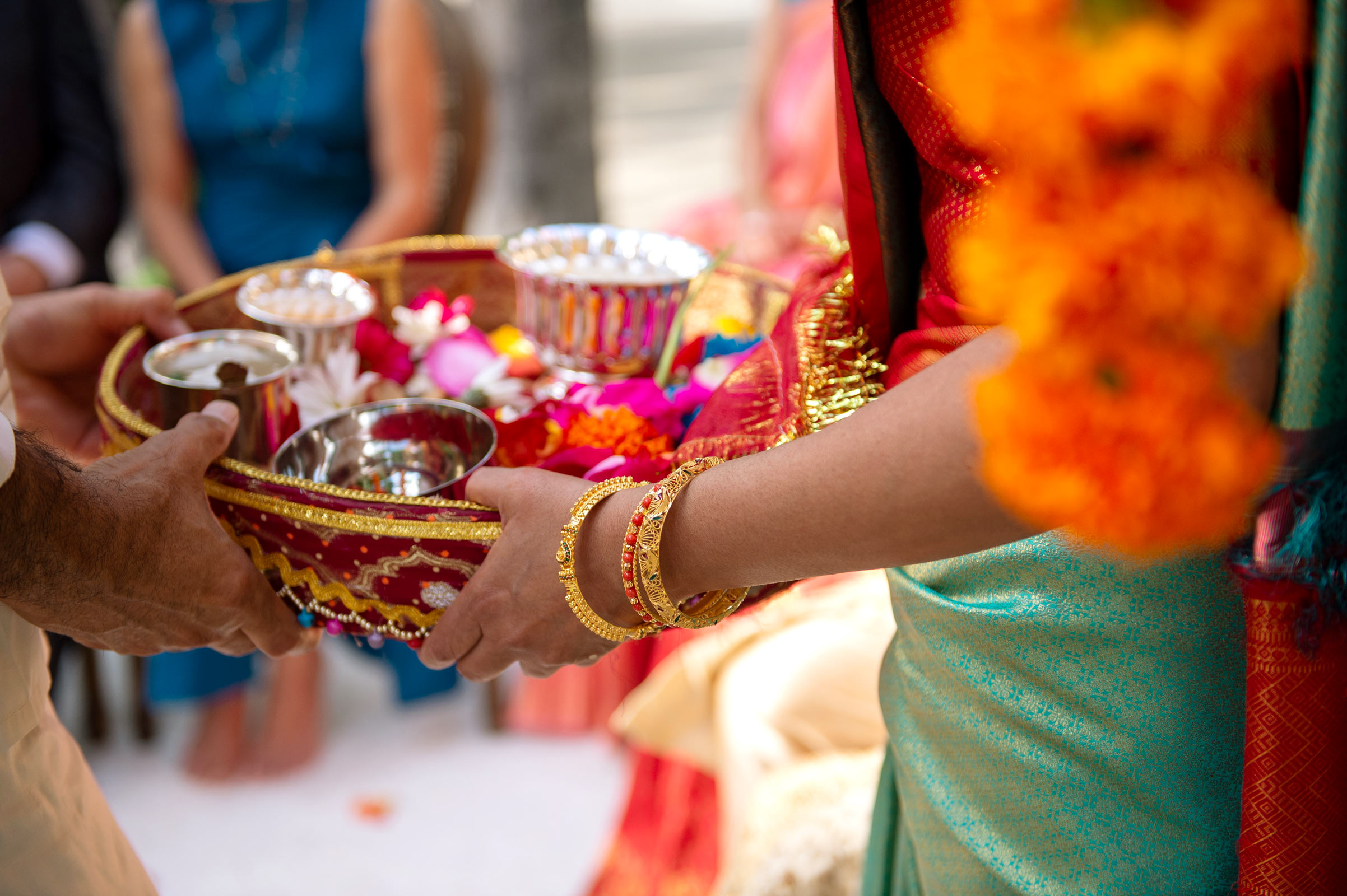 A close-up image of the hands of individuals exchanging ritual items for the ceremony.