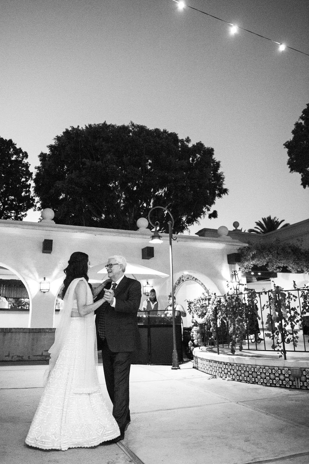 Wideshot in black-and-white of A with her dad dancing.